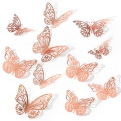 many pink butterflies are flying in the air on a white surface, with shadows coming from them