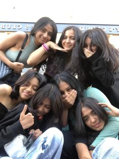 group of girls posing for the camera with their thumbs up