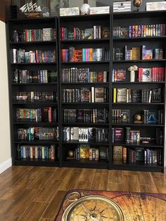 a book shelf filled with lots of books on top of a hard wood flooring