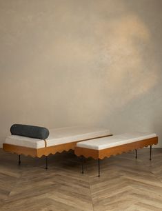 two wooden benches sitting next to each other on top of a hard wood floored floor