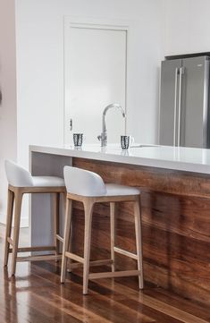 two stools in front of a kitchen island