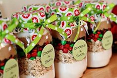 small jars filled with cookies and candy are sitting on a table next to each other