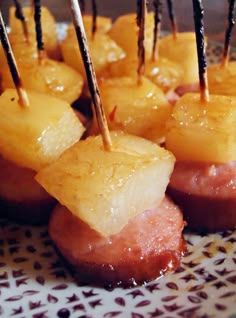 pineapple and ham bites with toothpicks on a plate