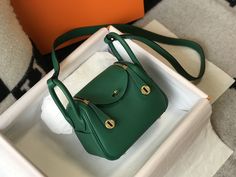 Description HRMS Lindy Mini Clemence Bag Green For Women, Women’s Handbags, Shoulder And Crossbody Bags 7.5in/19cm Rep 1:1 The mini Lindy bag made its debut at the Hermès Fall/Winter 2019 runway show. The Mini Lindy is true to its roots: it essentially functions as any Lindy bag, with the added bonus of a cross-body strap (so it’s extra-practical). The unusual placement of the handles gives the bag its atypical shape, and you can carry it in the hand or via the strap. 19 x 12.5 x 9 cm / 7.5 x 5 x 3.5 inches (Length x Height x Width) Green Double rolled handles with shoulder strap Two zippers with clasp and turnlock closure Exterior two side flat pockets Interior two side flat pockets Four protective feet at the bottom Gold-toned hardware – Includes box, dust bag. – This product is of the b Hermes Lindy Mini, Hermes Lindy Bag, Mini Lindy, Hermes Lindy, Louis Vuitton Shirt, 2019 Runway, Handcrafted Accessories, Bag Green, Luxury Products