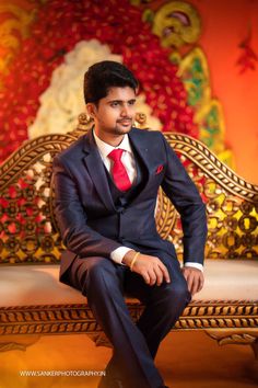 a man in a suit sitting on a bench