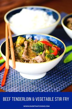 beef and vegetable stir fry served in bowls with chopsticks on the table top