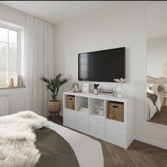 a bedroom with a large flat screen tv mounted to the side of it's wall