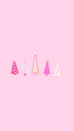 christmas trees are lined up against a pink background