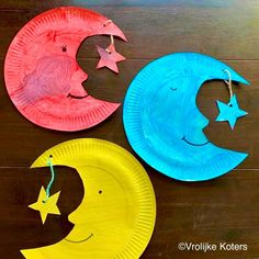 three paper plates with different shapes and sizes of moon and stars on them sitting on a wooden surface