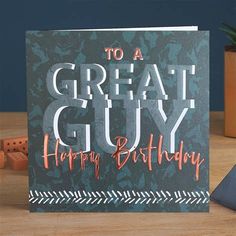 a greeting card with the words to a great guy on it, sitting next to some dice