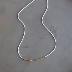 Our lithe necklace is handcrafted with a touch of gold in a minimalist style. •Seed beads hand strung in a minimalist pattern •Choose between blush or light blue •14kt Gold-Filled accents •16 inches in length or 16 inches with a 2 inch extender Yellow Gold Beaded Necklaces For Everyday, Minimalist Single Strand Beaded Necklace, Minimalist Single Strand Gold Beaded Necklace, Minimalist White Beaded Necklaces For Everyday, Gold Minimalist Single Strand Beaded Necklace, Everyday Gold Beaded Necklaces, Minimalist Gold Single Strand Beaded Necklace, Minimalist White Beaded Necklace For Everyday, Minimalist Everyday White Beaded Necklaces