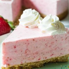 a slice of strawberry cheesecake with whipped cream on top