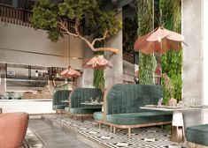 the interior of a restaurant with green velvet booths and pink umbrellas hanging from the ceiling