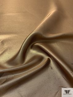 the fabric is shiny and gold in color