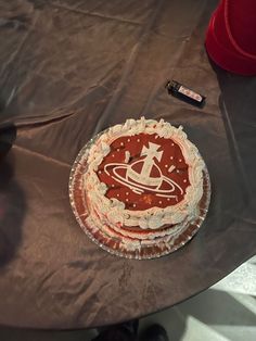 a cake sitting on top of a table covered in frosting