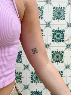 a woman with a small tattoo on her arm