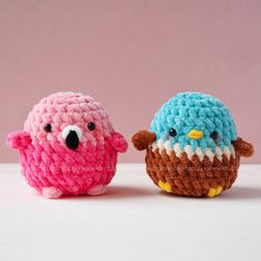 two small crocheted birds sitting next to each other