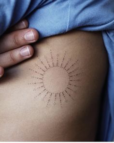 a woman's stomach with the sun drawn on it