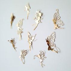 a group of different types of fairy brooches on a white surface with one being cut out and the other is laying down