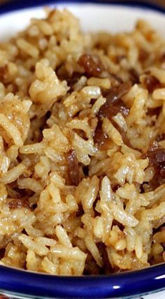 a bowl filled with rice and meat on top of a table