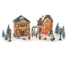 a group of miniature buildings with christmas decorations on the front and side of each building