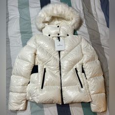 Women’s Moncler Celac Giubbotto Down Feather Puffer Parka Jacket In Size 4 (Medium In Usa Sizing). Very Very Light Cream Color. Brand New, Never Worn. Tags Still Attached. Extra Buttons Included. Detachable Fur Hood. Original Price $2055. Guaranteed 100% Authentic. Poshmark Will Verify Authenticity For Free Before It Gets To You, So There’s An Extra Level Of Protection. Can Provide Measurements Or More Photos Upon Request. Luxury White Puffer Jacket With Padded Collar, Luxury White Winter Outerwear, White Fitted Luxury Outerwear, Elegant Long Sleeve Puffer Jacket, Luxury White Puffer Jacket For Winter, Luxury White Winter Puffer Jacket, Luxury White Puffer Outerwear, Designer White Winter Outerwear, Designer Fitted Puffer Jacket For Winter