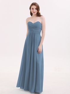 a woman in a strapless dress poses for the camera with her hands on her hips