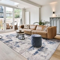 a living room with a couch, chair and table in it's center area