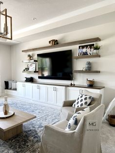 a living room filled with furniture and a flat screen tv mounted on a wall above a fireplace