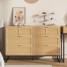 a bedroom scene with focus on the dresser and sideboard in the foreground, along with a bed