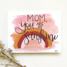 a card with the words mom, you are my sunshine and a rainbow painted on it