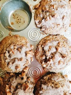 several cookies are sitting on a plate next to a measuring cup