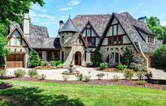 this is an image of a beautiful house in the country side with stone and wood accents