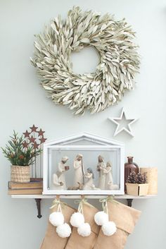 a christmas stocking hanging from a shelf with stockings on it and decorations in the background