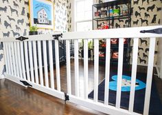 a baby gate in the middle of a room with black and white animal wallpaper