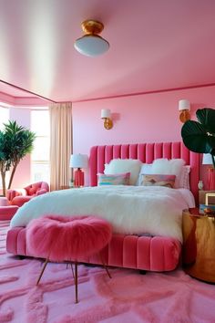 a bedroom with pink walls and white bedding in the center, along with two planters on either side of the bed