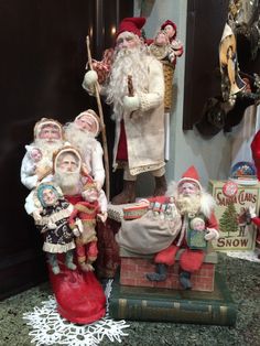 a group of santa claus figurines sitting on top of a table