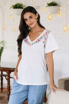 Feast your eyes on this charming v-neck t-shirt presented by Sonik Sethi. Crafted by Indian artisans from 100% cotton jersey fabric, the off-white top features a colorful embroidered floral motif along the neckline, and lateral slits for extra comfort. Spring Embroidered V-neck T-shirt, White Cotton V-neck T-shirt, Cotton V-neck T-shirt With Floral Embroidery, White V-neck T-shirt For Summer, White Embroidered T-shirt For Summer, Embroidered V-neck T-shirt For Summer, Spring Cotton V-neck T-shirt, Casual V-neck T-shirt With Floral Embroidery, Spring V-neck Cotton T-shirt