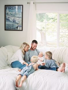 a family sitting on a bed together