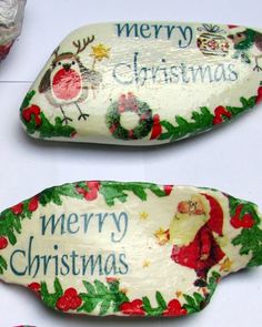 two christmas decorations are sitting on a table