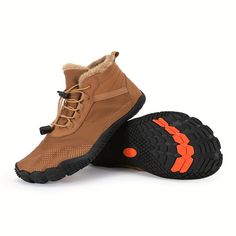 a pair of brown shoes with orange accents on the soles and black outstep