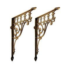 pair of ornate gold metal brackets on white background with clipping for text or image