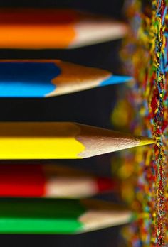 many colored pencils are lined up together