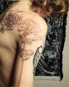 a woman with a tree tattoo on her arm