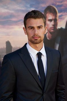 a man in a suit and tie posing for the camera