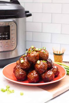 a plate full of meatballs next to an instant pressure cooker with celery