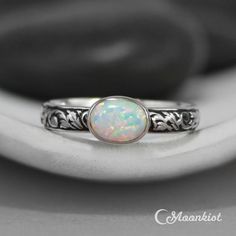 a white opal ring sitting on top of a table