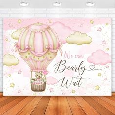 a pink and white wall mural with a bear in a hot air balloon on it