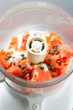 a food processor with salmon and capers in it