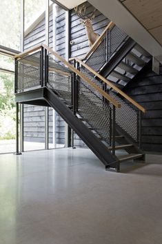 an open staircase with metal railings leading up to the second floor